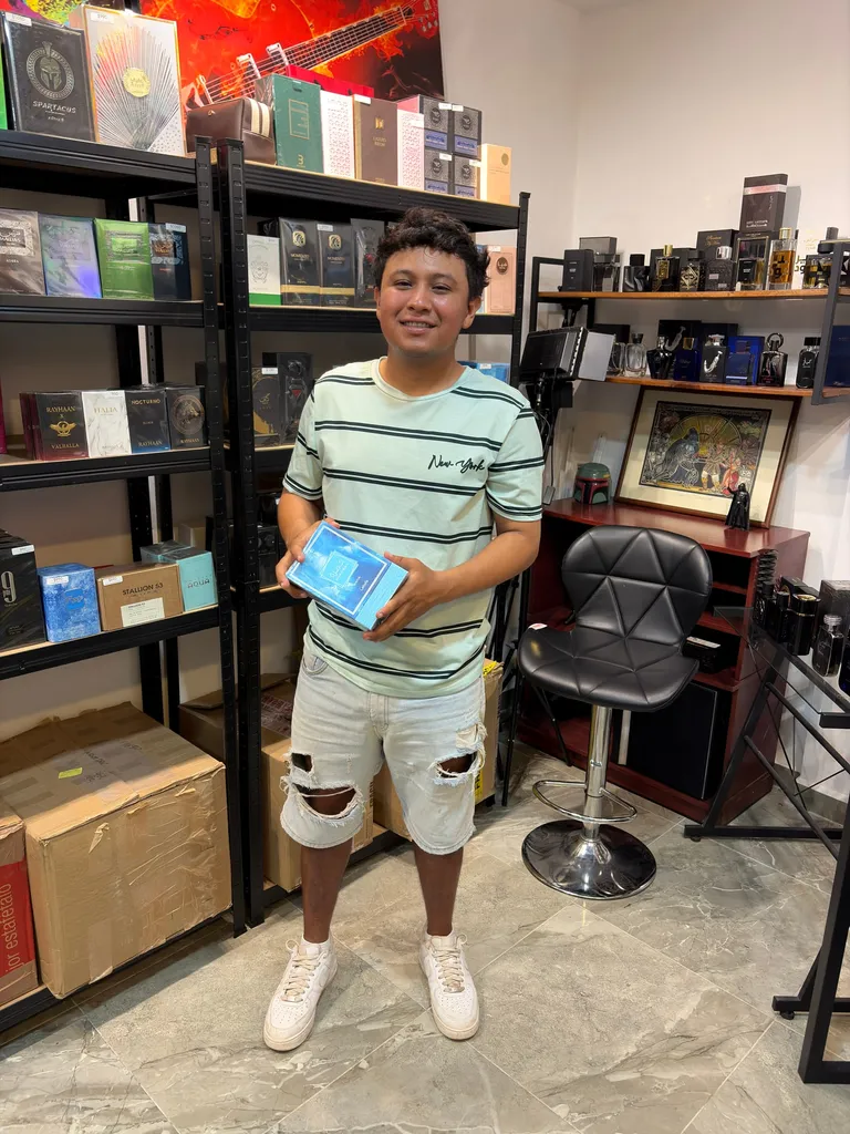 Cliente sosteniendo una caja de perfume dentro de El Barbón de los Perfumes en Mérida